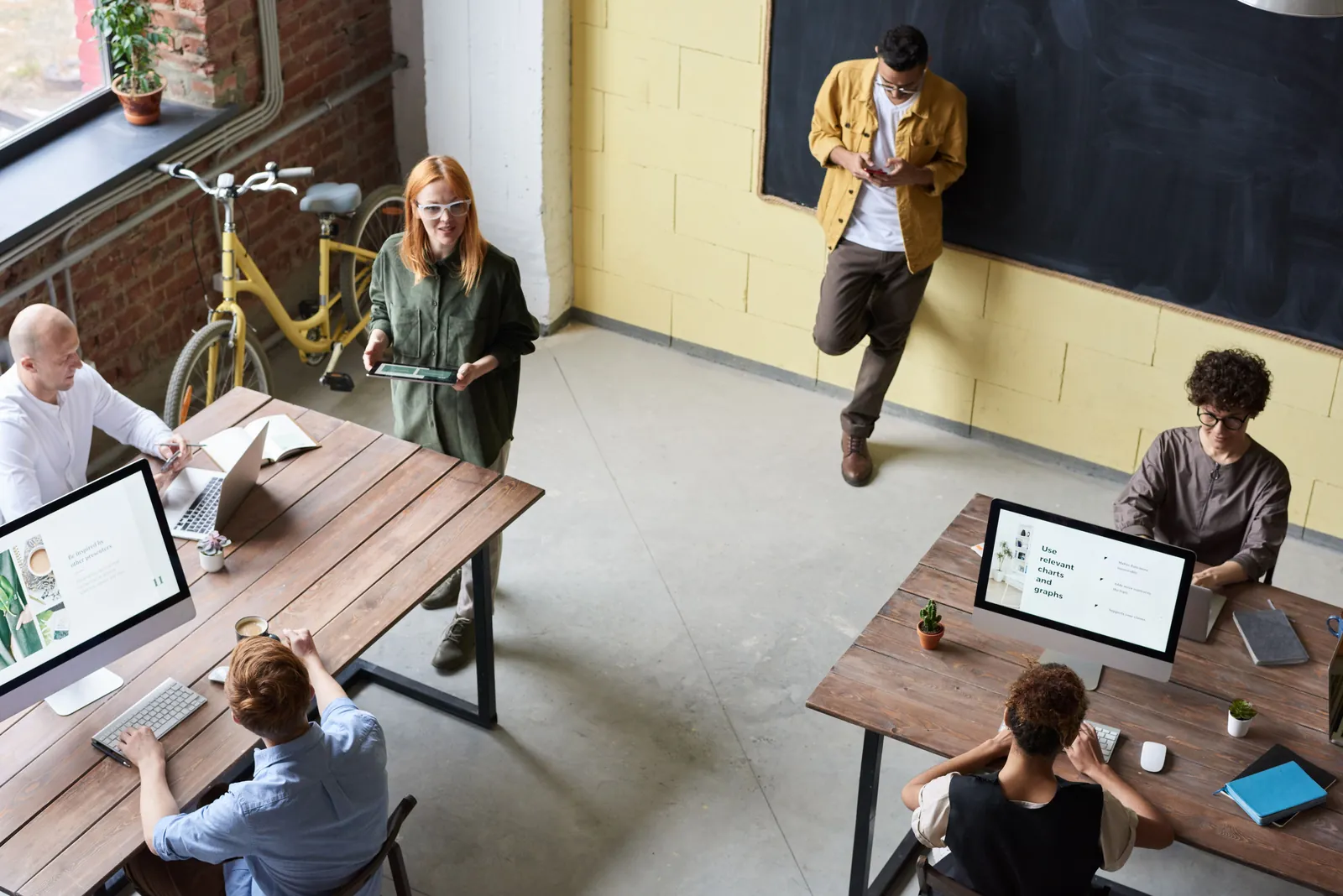 Team members working at desks in a bright open-plan office