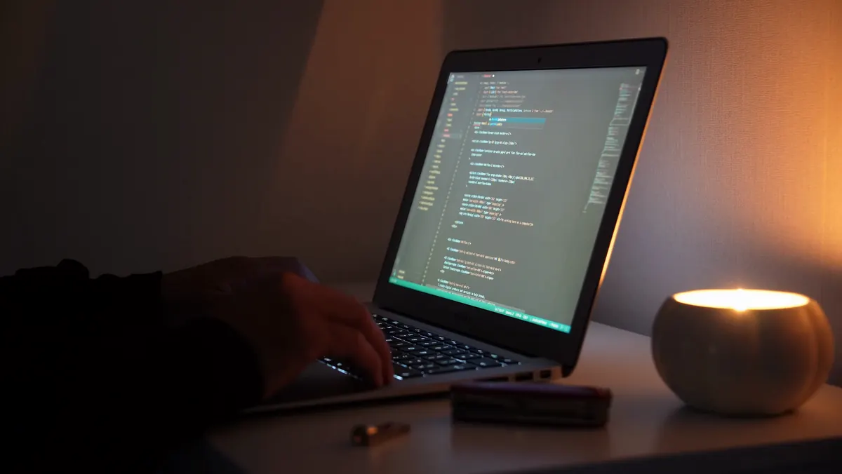 Code on a laptop screen in warm light