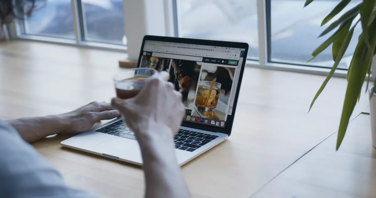 Person browsing a photo gallery site on a laptop